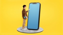 Student Young Man Touching Huge Phone With Empty Screen Template For E-Learning Apps Advertisement, Standing With Textbooks On Yellow Studio Background. Gadget Offer. Collage