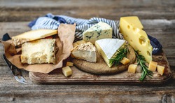 Savory pieces of cheese served with nuts and rosemary