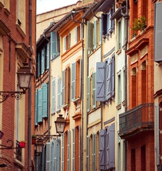 Narrow historic street with old buildings in Toulouse, France