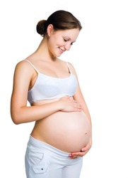 pregnant woman caressing her belly over white background
