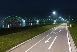 Bicycle lane with white bicycle sign at night