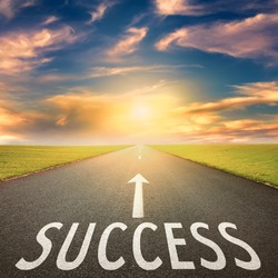 Driving on an empty asphalt road towards the setting sun and sign which symbolizing success. Concept for success.
