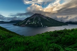 Untouched pristine nature of Onekotan Island, small volcanic island in the Sea of Okhotsk, part of Kuril chain of islands. Krenitsyn volcano is in the center of caldera lake.