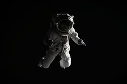 Full portrait of Caucasian female astronaut during spacewalk, black deep space background