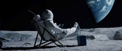 Astronaut sits in a beach chair on a Moon surface, holding phone in hands