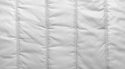 Bologna fabric seamed texture surface, white colored material.