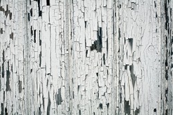 Background of white, peeling paint on an old wall