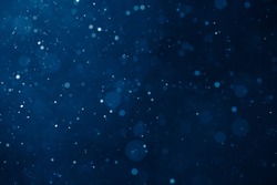 blue light background with snowflakes particles 