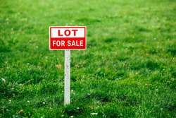 lot for sale plate sign, green grass background