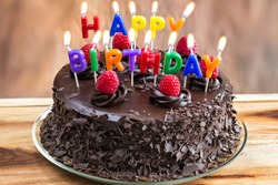 Happy Birthday candles on chocolate cake