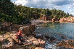 hiker taking in the views in Acadia National Park