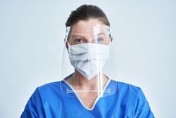 Portrait of female medical doctor wearing protective mask and face shield