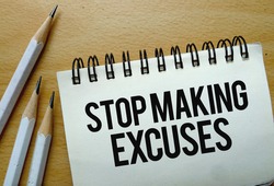 Stop Making Excuses text written on a notebook with pencils