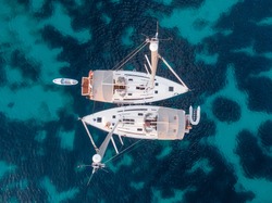top view of two sailboats anchored at sea