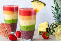 Colorful rainbow layered fruit smoothie