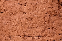 clay earthen wall texture background red - stock image