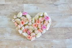 vintage heart from flowers on wooden texture - Valentine's Day heart of flowers