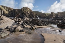 Sandy beach and ancient rocks at Sandymouth Cornwall