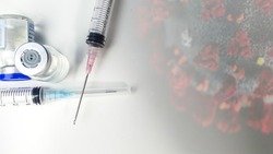 Medical Concept of composite photo of syringe and illustrative of virus by Centers for Disease Control and Prevention (CDC) in background including copy space