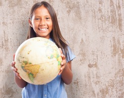 portrait of cute girl holding a world globe