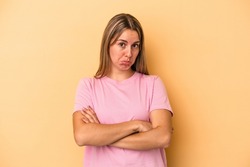 Young caucasian woman isolated on yellow background tired of a repetitive task.