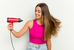 Young Indian woman holding a hairdryer isolated on white background