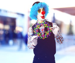 portrait of a funny clown playing with a toy ball