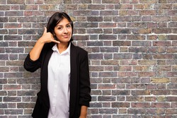 latin business woman doing telephone gesture