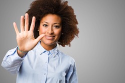 young black woman doing number five gesture