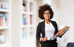 business black woman holding a cup of coffee and files