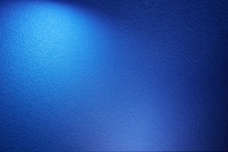 A wide volume beam of light blue on a blue texture background