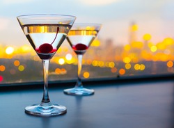Cocktail glasses with city view.
