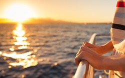 Closeup of female hands on a cruise ship  during sunset.  