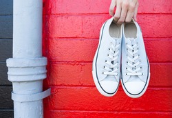 Pair of shoes against red brick background. 