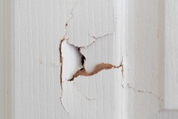 Close up of broken white wooden door.