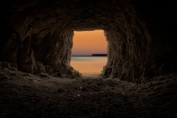 Exit from the cave overlooking the evening sea.