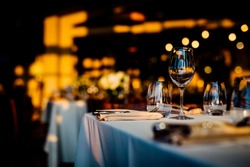 Luxury table settings for fine dining with and glassware, beautiful blurred  background. For events, weddings.  Preparation for holiday  passover, props for weddings, birthdays, and celebrations.
