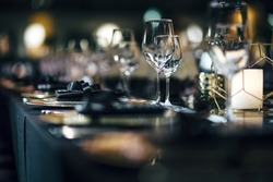 Luxury table settings for fine dining with and glassware, beautiful blurred  background. Preparation for holiday  Christmas and Hannukah dinner night.