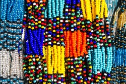 African tribal necklaces in vibrant colours. Closeup of intricate bead work for sale at a street market in South Africa.