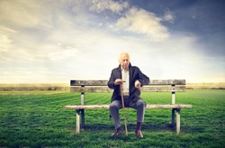 senior man sitting on a bench outdoor