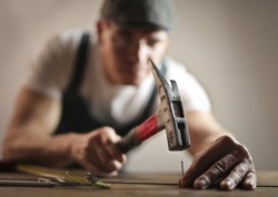 Carpenter hammering a nail
