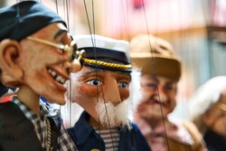 Selective focus of old sailor Puppets hanging at the souvenir store. Prague. Souvenir puppets (Marionettes)