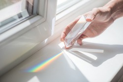 Transparent prism for light education expriments in a man's'hand