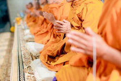 Pray of monks on ceremony of buddhist in Thailand. Many Buddha monk sit on the red carpet prepare to pray and doing buddhist ceremony.
