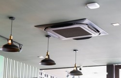 Modern ceiling mounted cassette type air conditioning system in coffee shop