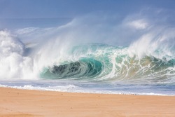 giant wave breaking on the beach in hawaii