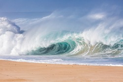 huge wave breaking on the beach