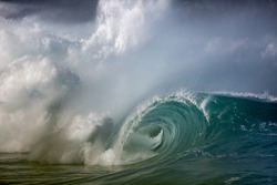 large wave breaking in hawaii, spray, intense, barreling, powerful.