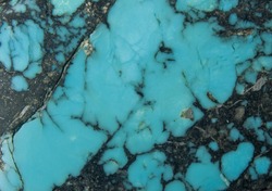Close up of hand carved turquoise stone