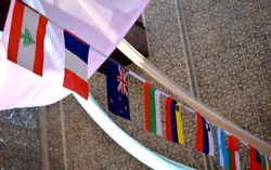 Flags of many countries, including UK, put together on a string in an international conference